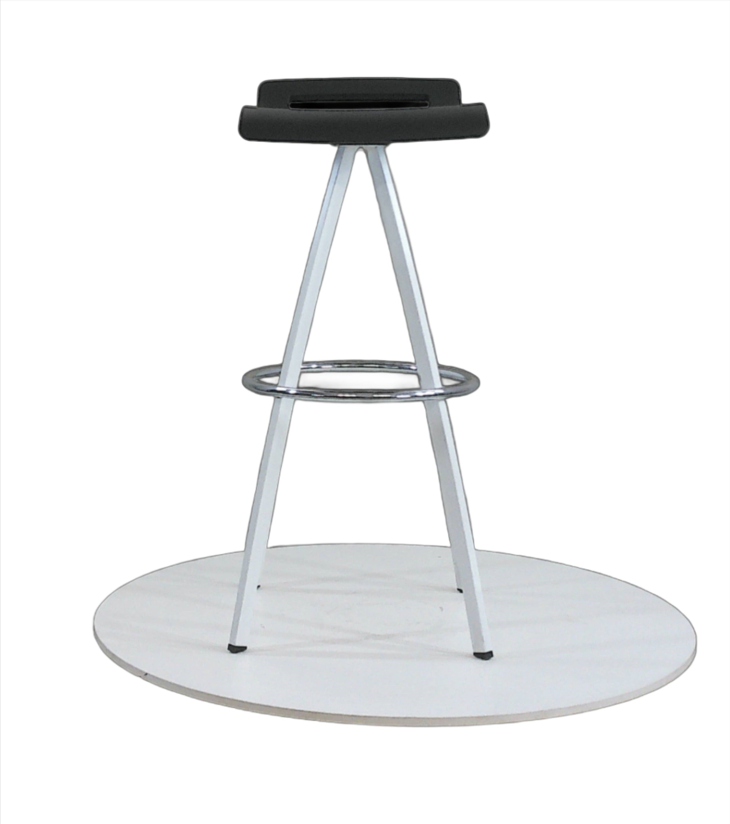 Bar stool with white powder coated 4 leg base and black seat with low back on a grey background